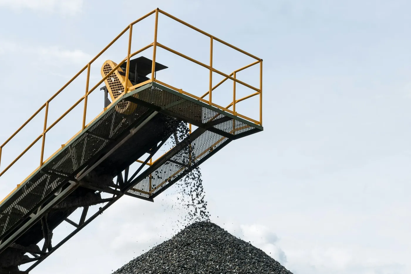 A conveyor stacker building a graded stockpile